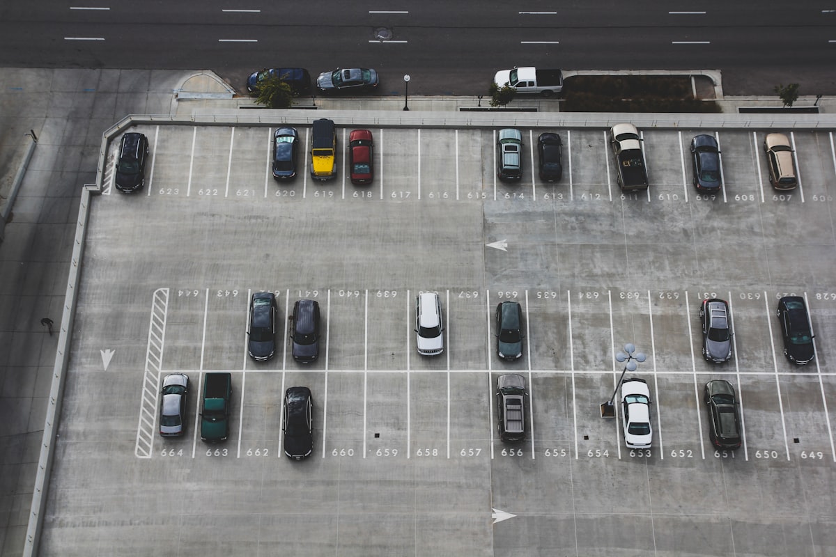 Aerial view of a large car auction lot with rows of vehicles