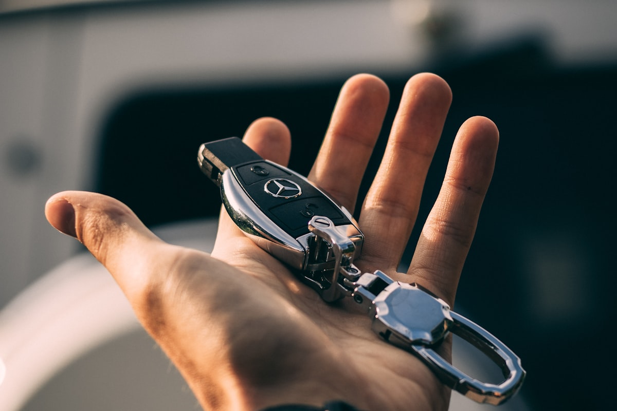 Car keys on a black vehicle surface representing vehicle ownership and insurance